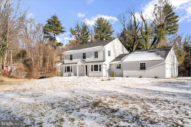 view of snow covered back of property