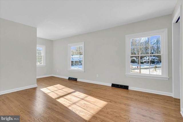 unfurnished room featuring light hardwood / wood-style floors