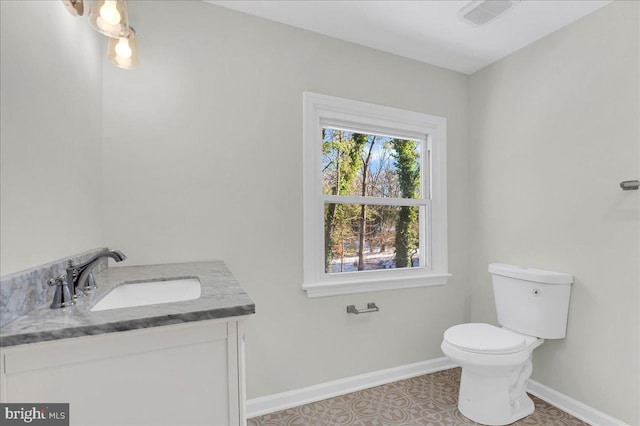 bathroom featuring tile patterned floors, vanity, and toilet