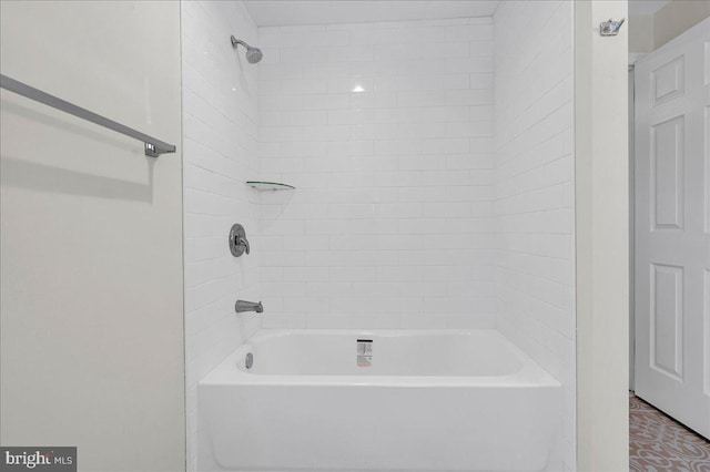 bathroom with tile patterned floors and tiled shower / bath