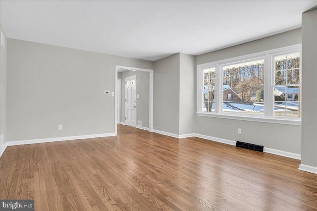 unfurnished room with wood-type flooring