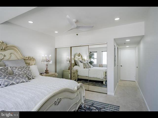 carpeted bedroom featuring a closet and ceiling fan