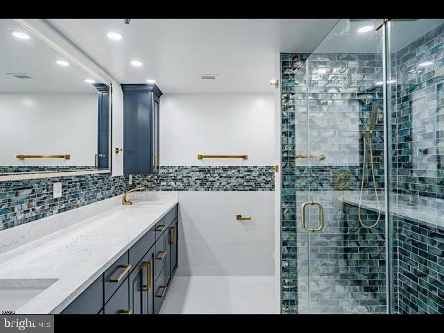 bathroom featuring vanity and an enclosed shower