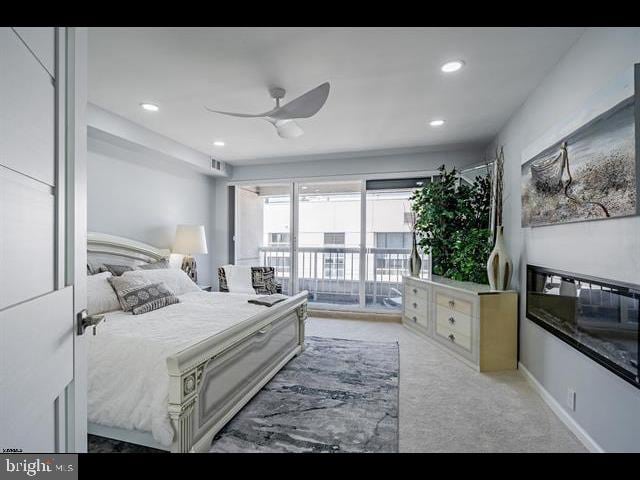 bedroom featuring light colored carpet, access to exterior, and ceiling fan