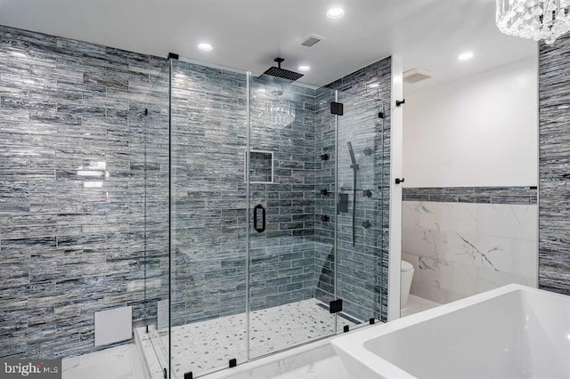 bathroom with tile walls and independent shower and bath