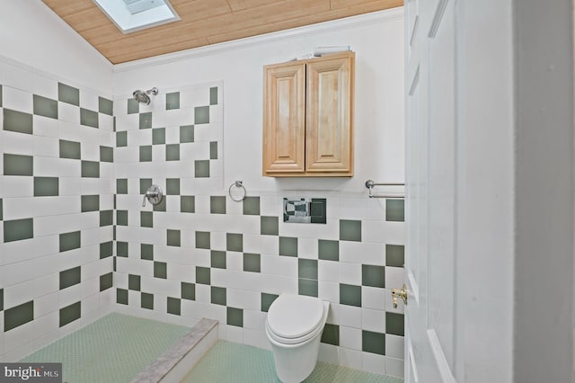 bathroom with toilet, wood ceiling, a tile shower, tile patterned flooring, and lofted ceiling