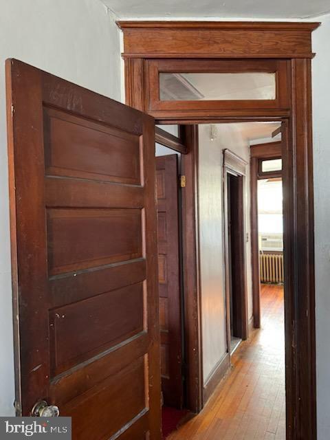 hall with radiator and light hardwood / wood-style flooring