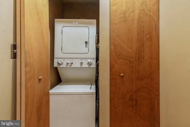 clothes washing area with stacked washer and dryer