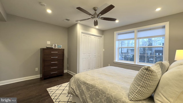 bedroom featuring dark hardwood / wood-style flooring, a closet, and ceiling fan