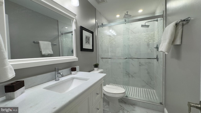 bathroom featuring vanity, toilet, and walk in shower