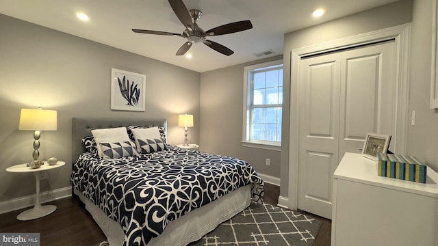 bedroom featuring dark hardwood / wood-style floors, a closet, and ceiling fan