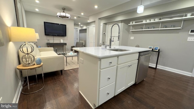 kitchen with sink, a center island with sink, dishwasher, dark hardwood / wood-style floors, and white cabinetry