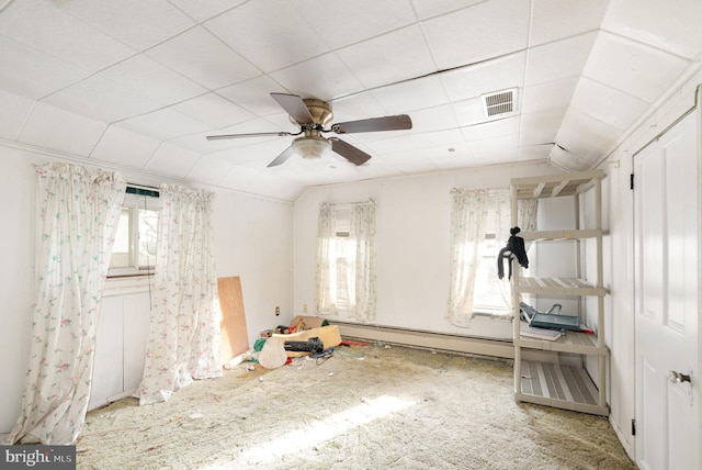 interior space featuring visible vents, lofted ceiling, baseboard heating, and a ceiling fan