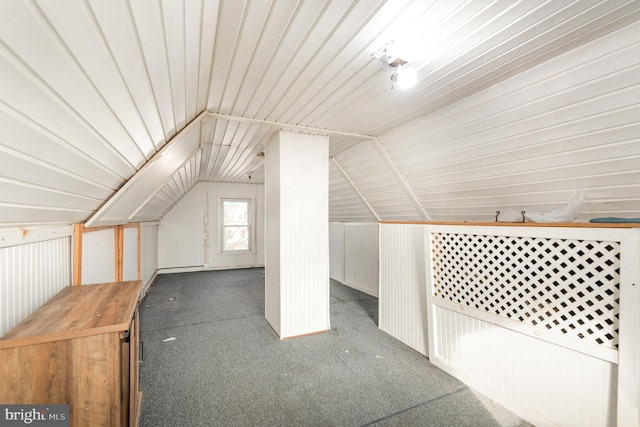 bonus room featuring carpet floors, metal wall, and vaulted ceiling