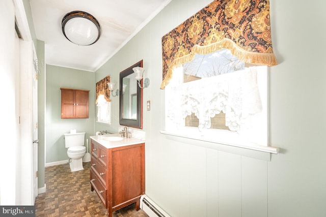 bathroom featuring vanity, baseboards, a baseboard radiator, crown molding, and toilet