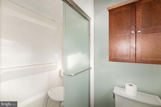 full bathroom with a shower stall and toilet