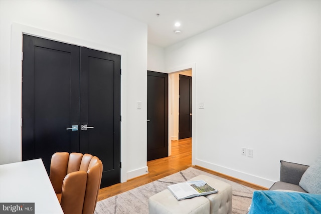 home office with light hardwood / wood-style flooring