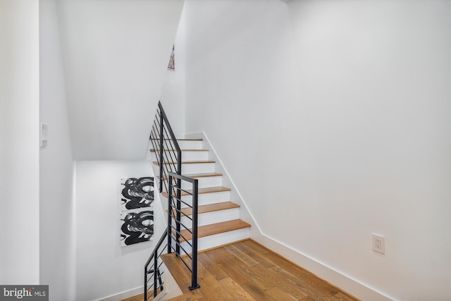 staircase with wood-type flooring