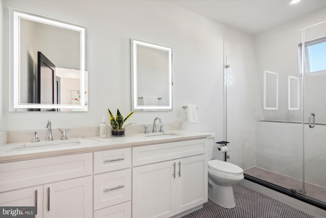 bathroom with toilet, a shower with door, vanity, and tile patterned flooring