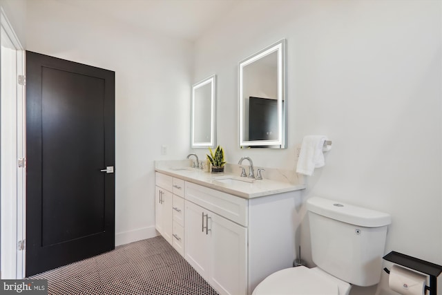 bathroom featuring tile patterned flooring, vanity, and toilet