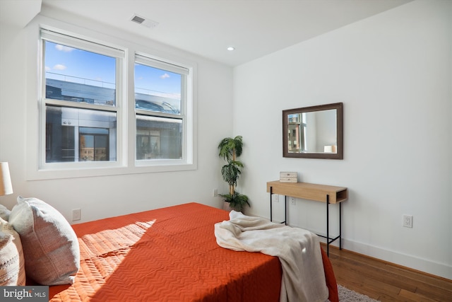 bedroom with hardwood / wood-style flooring