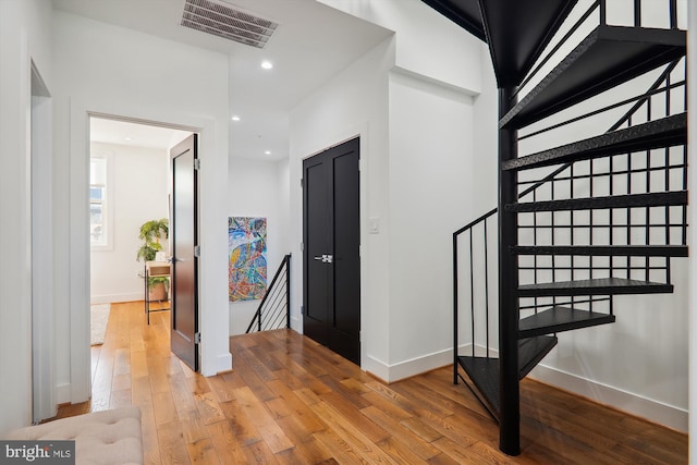 stairs featuring hardwood / wood-style flooring