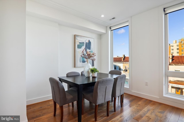 dining space featuring hardwood / wood-style flooring and a healthy amount of sunlight