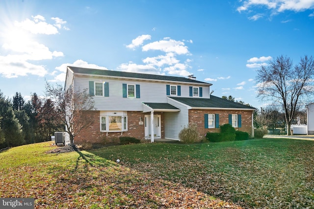 view of front property featuring central air condition unit and a front lawn