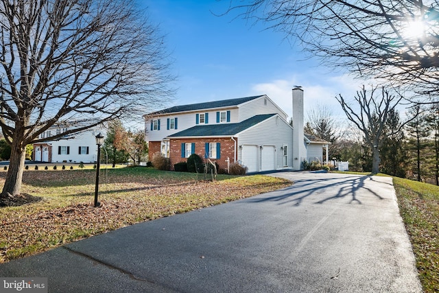 view of property with a garage and a front yard