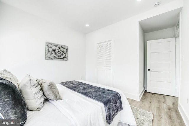 bedroom featuring light wood-type flooring and a closet