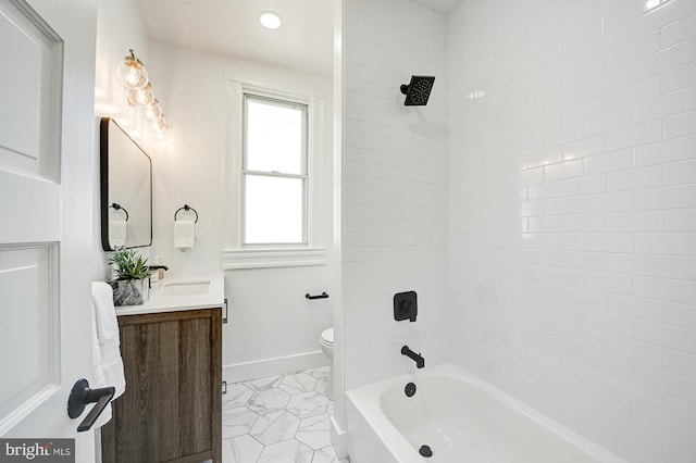 full bathroom with tiled shower / bath, vanity, and toilet