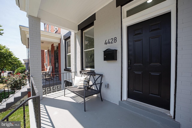 view of exterior entry featuring a porch