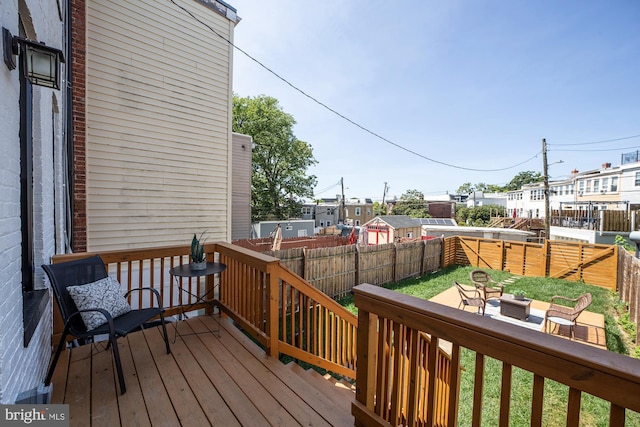 wooden deck with a yard and an outdoor hangout area