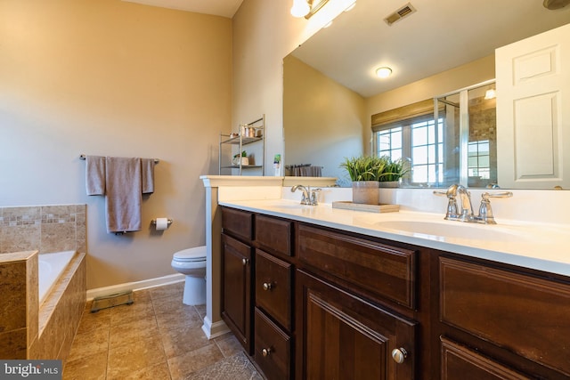 full bathroom featuring vanity, toilet, and separate shower and tub