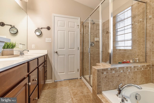 bathroom with vanity and separate shower and tub