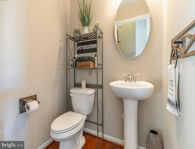 bathroom featuring hardwood / wood-style floors, toilet, and sink