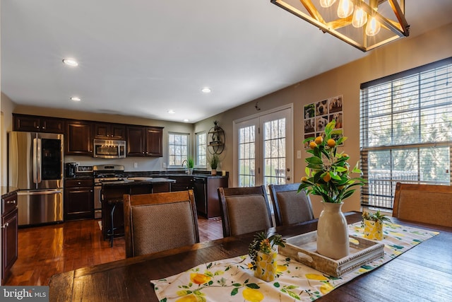 dining space featuring french doors and dark wood-type flooring