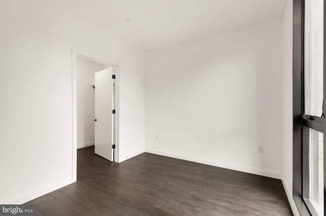 spare room with dark hardwood / wood-style floors