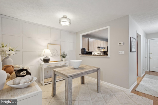 interior space featuring a textured ceiling and light wood-type flooring