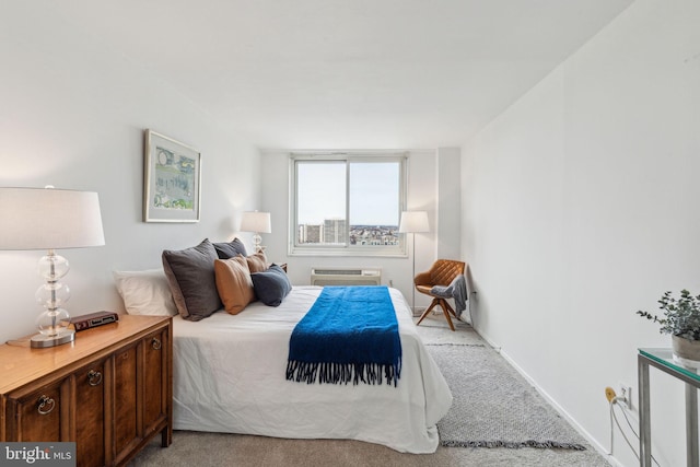 carpeted bedroom featuring a wall unit AC