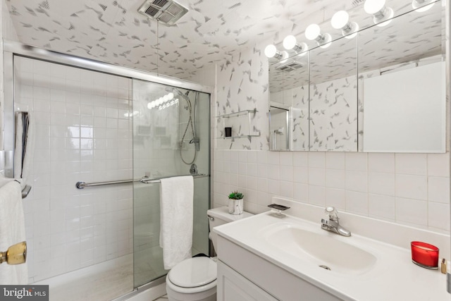 bathroom with backsplash, vanity, walk in shower, and toilet