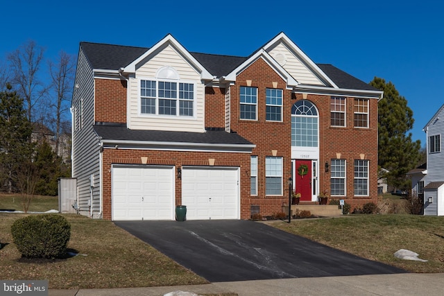 view of front facade with a garage and a front yard