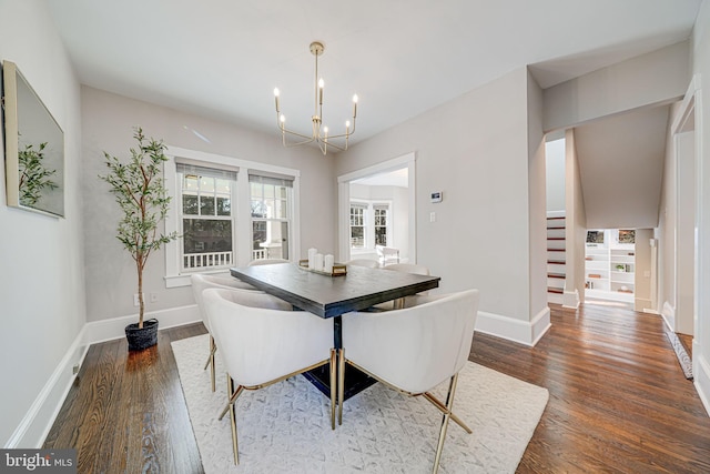 dining area featuring a chandelier, wood finished floors, stairs, and baseboards