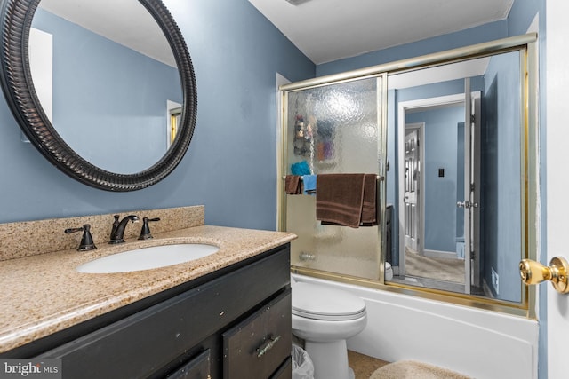 full bathroom featuring combined bath / shower with glass door, vanity, and toilet