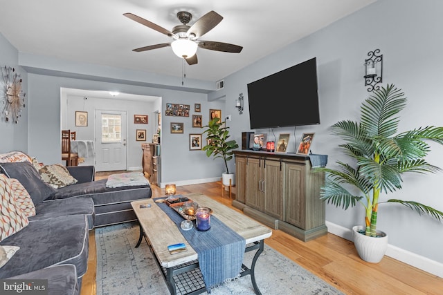 living room with ceiling fan and light hardwood / wood-style floors