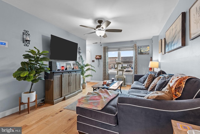 living room with ceiling fan and light hardwood / wood-style flooring