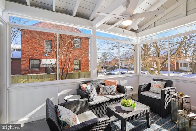 sunroom featuring lofted ceiling with beams, plenty of natural light, ceiling fan, and wood ceiling