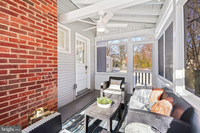 sunroom with lofted ceiling with beams and ceiling fan