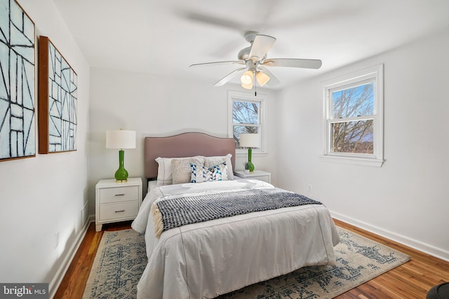 bedroom featuring dark hardwood / wood-style flooring and ceiling fan