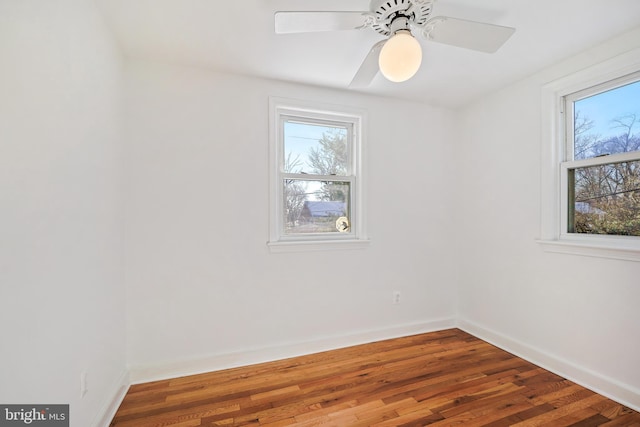 unfurnished room with ceiling fan and dark hardwood / wood-style floors